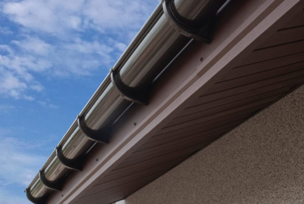 brown colored plastic gutter on house