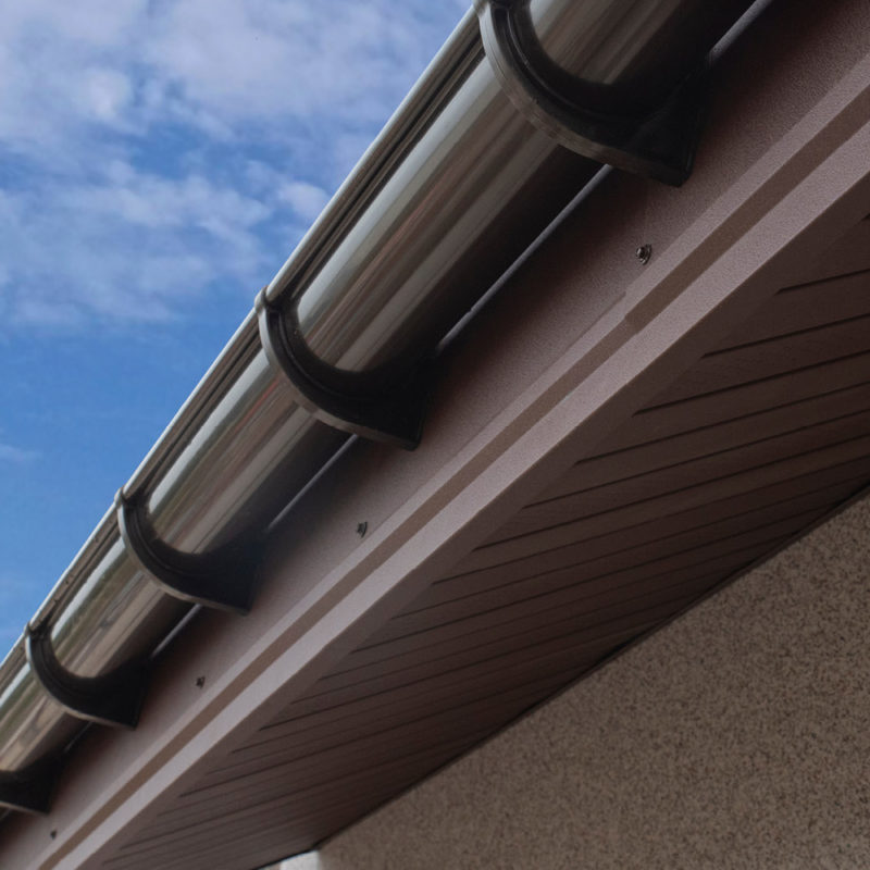 brown colored plastic gutter on house